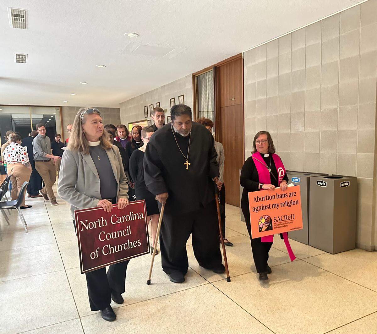 From left: Rev. Dr. Jennifer Copeland, Rev. Rev. William Barber and Rev. Dr. Rebecca Todd Peters. The coalition makes their way out of the legislative building to the governor’s mansion.