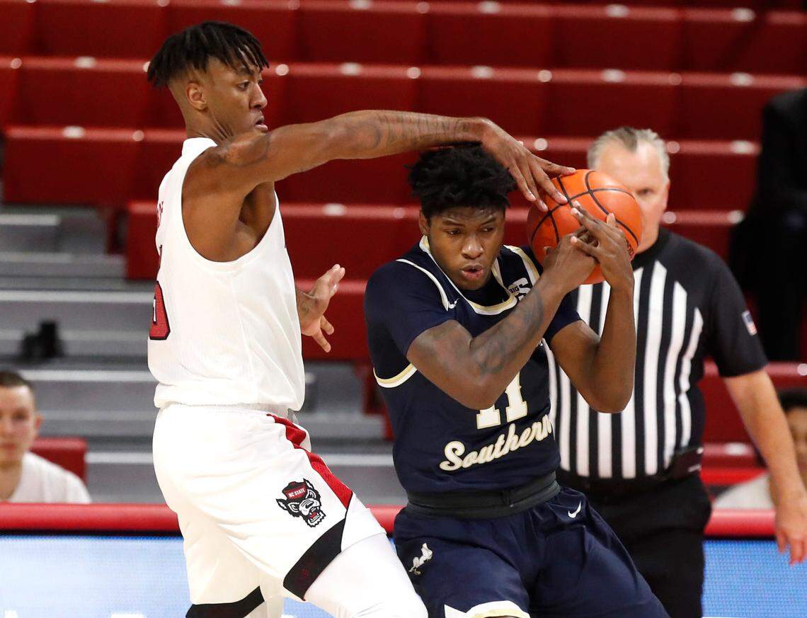 N.C. State’s Manny Bates (15) knocks the ball from Charleston Southern’s Ja’Quavian Florence (11) during the first half of N.C. State’s game against Charleston Southern in the Wolfpack Invitational at Reynolds Coliseum in Raleigh, N.C., Wednesday, Nov. 25, 2020.