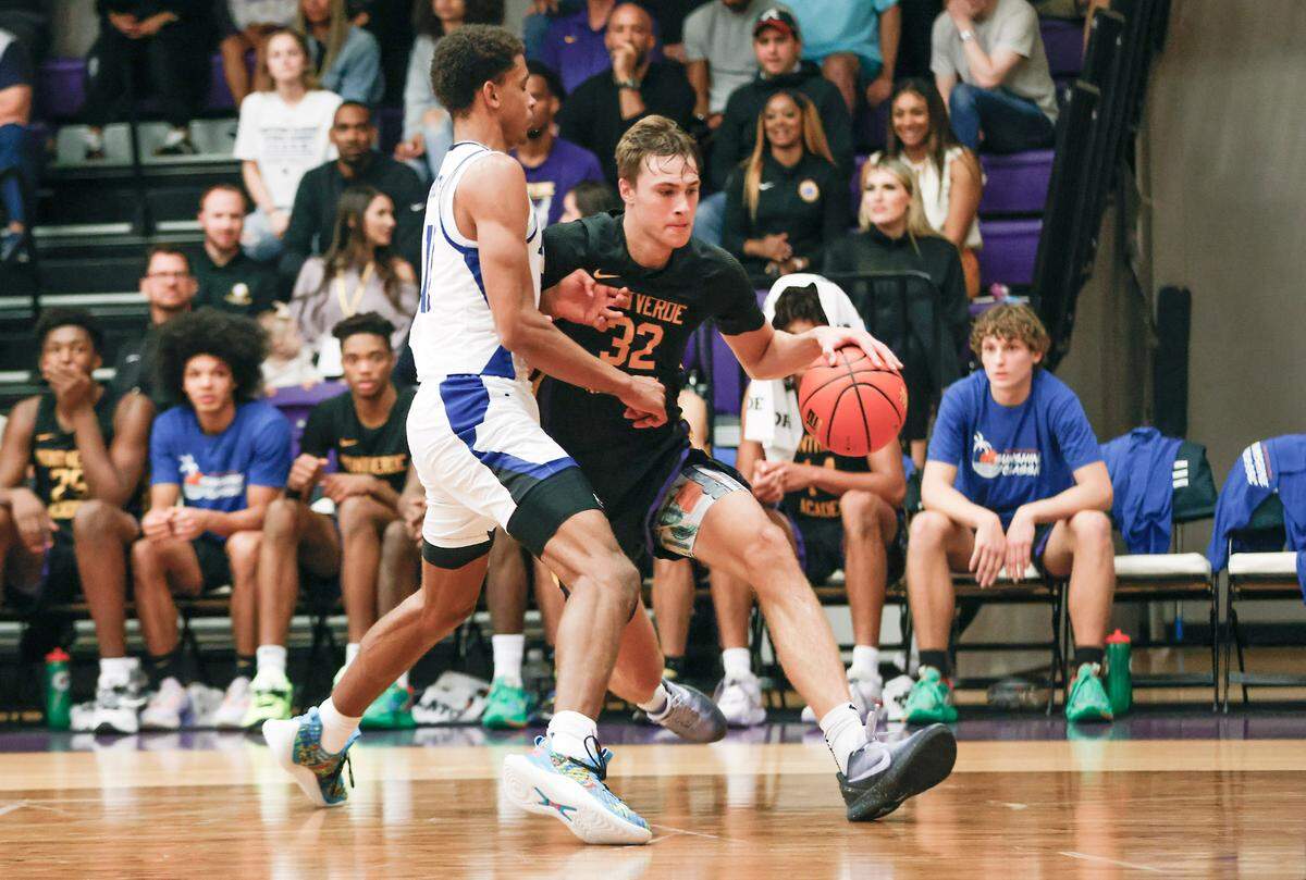 Dec 1, 2022; Montverde, Florida, USA; Montverde Academy forward Cooper Flagg (32) drives past IMG Academy forward Khani Rooths (left) during the second half of the Sunshine Classic basketball tournament at Mills Championship Court on the campus of Montverde Academy. Mandatory Credit: Reinhold Matay-USA TODAY Sports