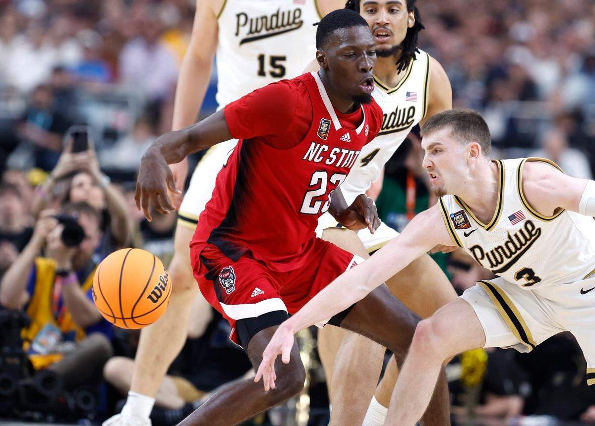 Purdue’s Braden Smith (3) knocks the ball from N.C. State’s Mohamed Diarra (23) during the first half of N.C. State’s game against Purdue in the NCAA Tournament national semfinals at State Farm Stadium in Glendale, Ariz., Saturday, April 6, 2024.