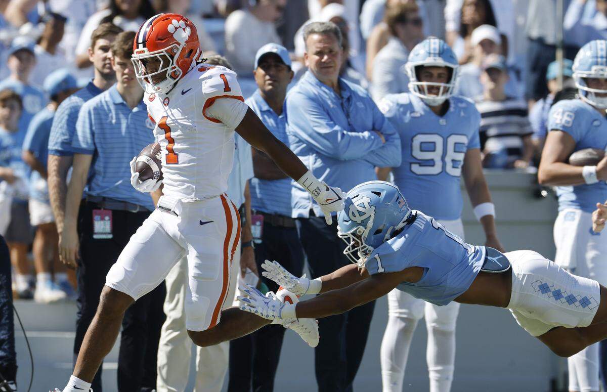 Clemson wide receiver T.J. Moore (1) beats North Carolina cornerback Thaddeus Dixon (1) to score on a 75-yard touchdown reception during the first half of UNC’s game against Clemson at Kenan Stadium in Chapel Hill, N.C., Sat. Oct. 4, 2025. The pass was thrown by Clemson’s Antonio Williams.