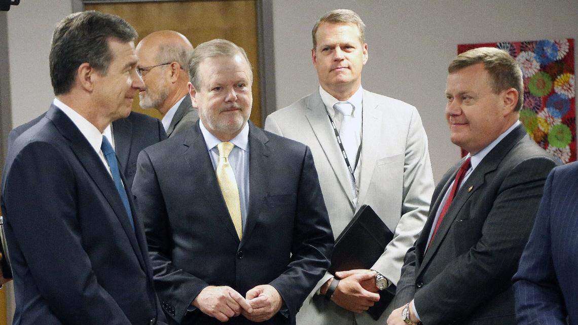 Governor Roy Cooper, left, Phil Berger, president pro tempore of the Senate, center, and Speaker of the House Tim Moore wait to walk to the podium before a press conference where the State Board of Community Colleges announced that Peter Hans will be the new president for the North Carolina’s community college system in 2018. Hans later went on to be named head of the UNC system.