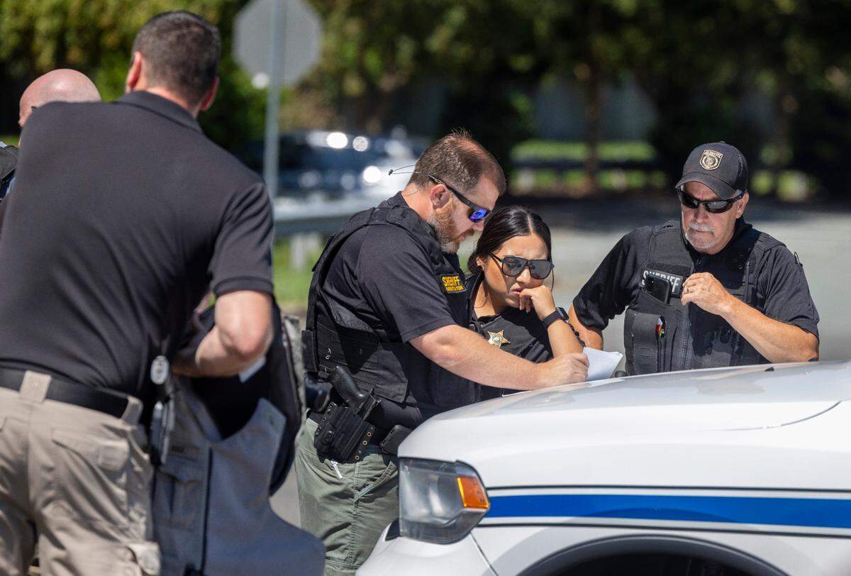 Alamance County Sheriff’s Deputies organize their search for escaped inmate Ramone Alston on Wednesday morning August 14, 2024 in Hillsborough, N.C. Alston, who was serving a life sentence for second degree murder, escaped on Tuesday morning at UNC Hospitals in Hillsborough as he was being transported from Bertie Correctional Institute to Hillsborough.