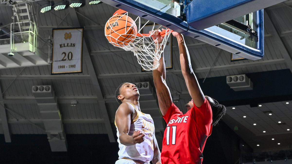 North Carolina State Wolfpack guard Dennis Parker, Jr. (11) dunks in front of Notre Dame Fighting Irish guard Markus Burton (3) in the second half at the Purcell Pavilion.