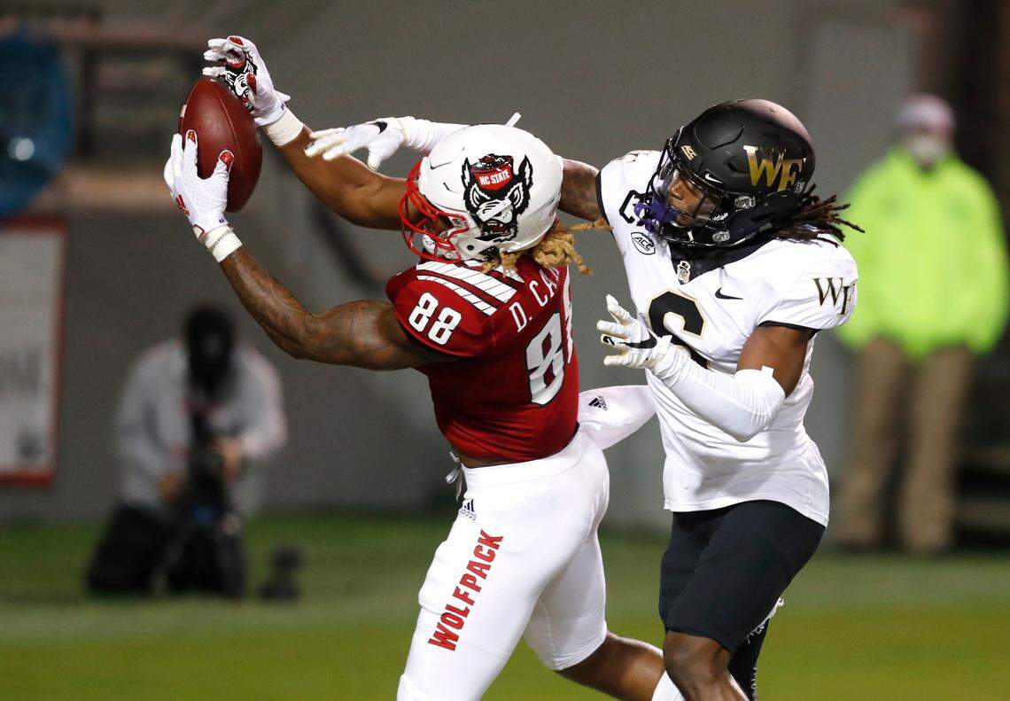 N.C. State wide receiver Devin Carter (88) pulls in a two-yard touchdown reception as Wake Forest defensive back Ja’Sir Taylor (6) defends during the second half of N.C. State’s 45-42 victory over Wake Forest at Carter-Finley Stadium in Raleigh, N.C, Saturday, Sept. 19, 2020.