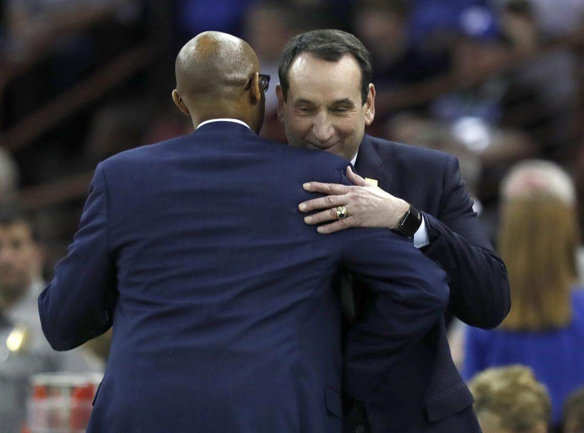 Duke head coach Mike Krzyzewski hugs UCF head coach Johnny Dawkins before Duke’s game against UCF in the second round of the NCAA Men’s Basketball Championship in Columbia, S.C., Sunday, March 24, 2019.