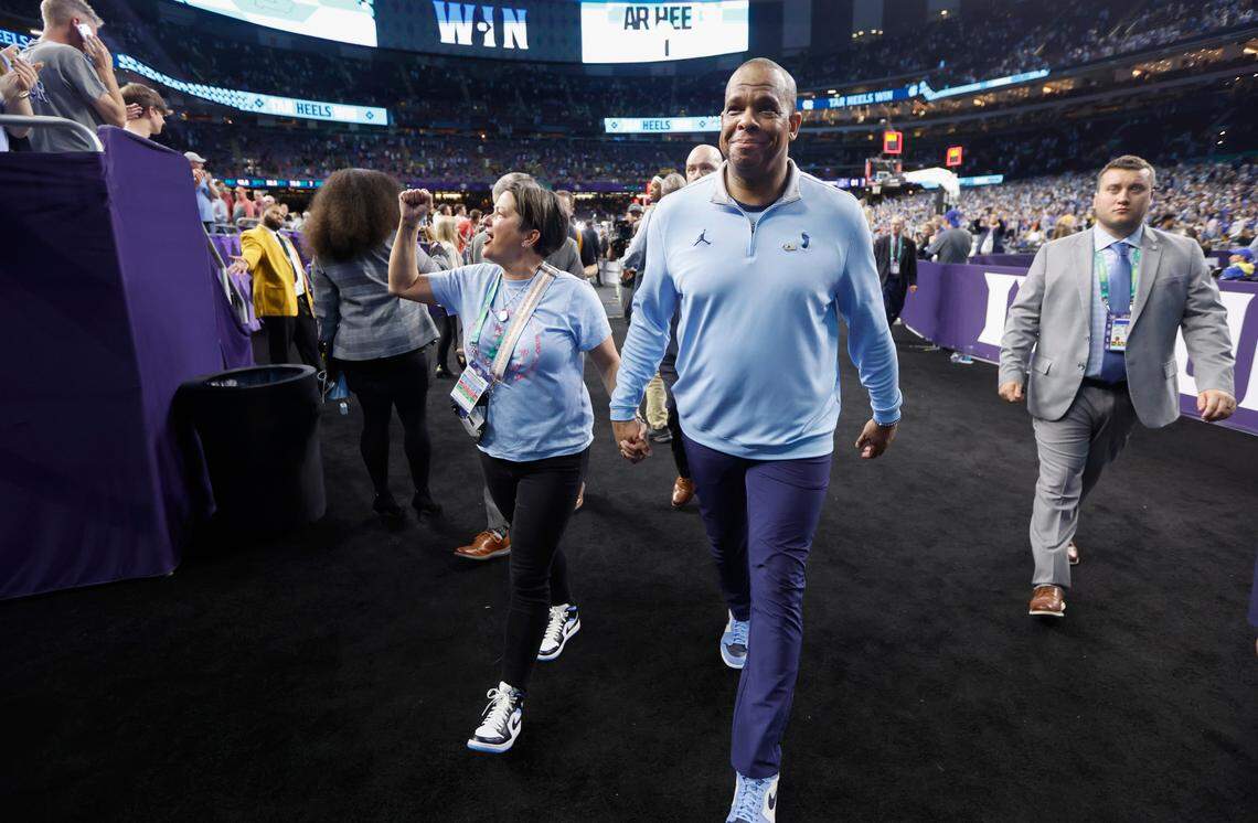North Carolina head coach Hubert Davis and his wife Leslie leave the arena floor after UNCís 81-77 victory over Duke in the Final Four at Caesars Superdome in New Orleans, La., Saturday, April 2, 2022.