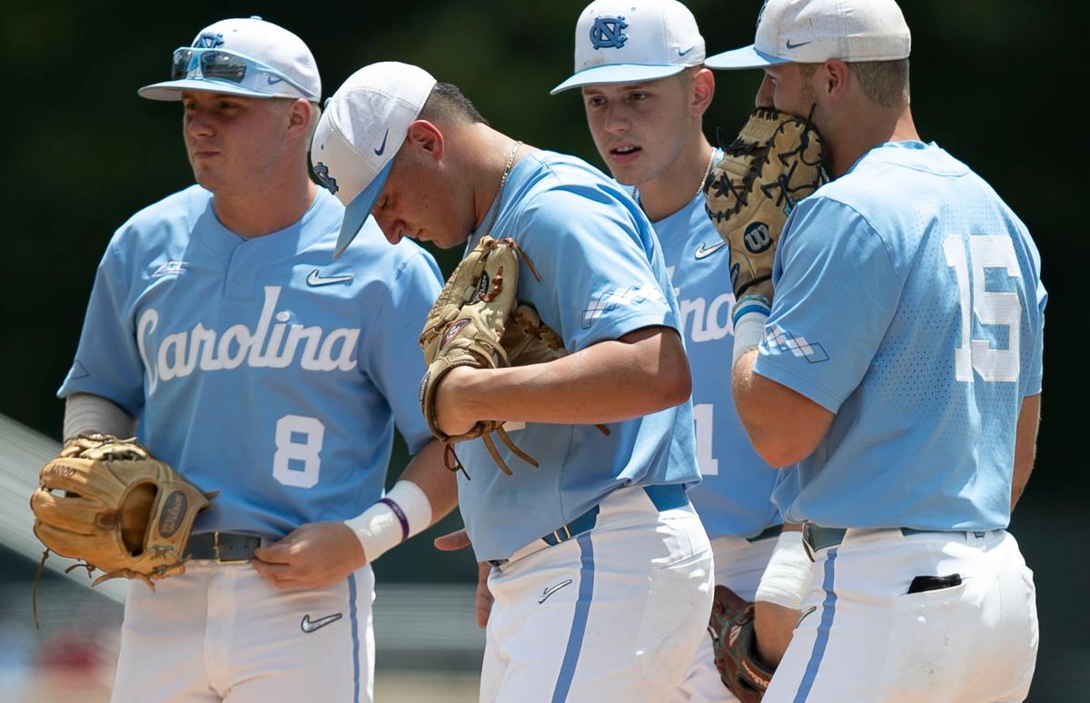 North Carolina starting pitcher Joey Lancellotti (31) is surrounded by teammates Michael Busch (15), Danny Serretti, and Ike Freeman (8) as they wait on coach Mike Fox’s arrival at the mound during the first inning against Auburn during the NCAA Super Regional on Monday, June 10, 2019 at Boshamer Stadium in Chapel Hill, N.C. Lancellotti gave up four runs in the top of the first inning and was replaced by Connor Ollio.