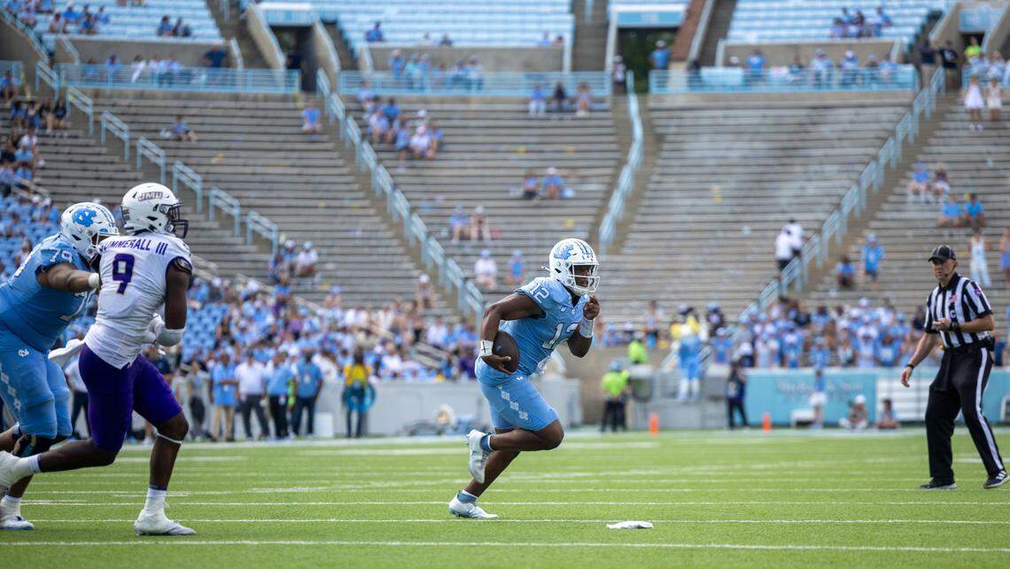 Down 63-38 to James Madison, with the west end of Kenan Stadium noticeably empty, North Carolina quarterback Jacolby Criswell (12) rushes for seven yards in the fourth quarter on Saturday, September 21, 2024 at Kenan Stadium in Chapel Hill, N.C.