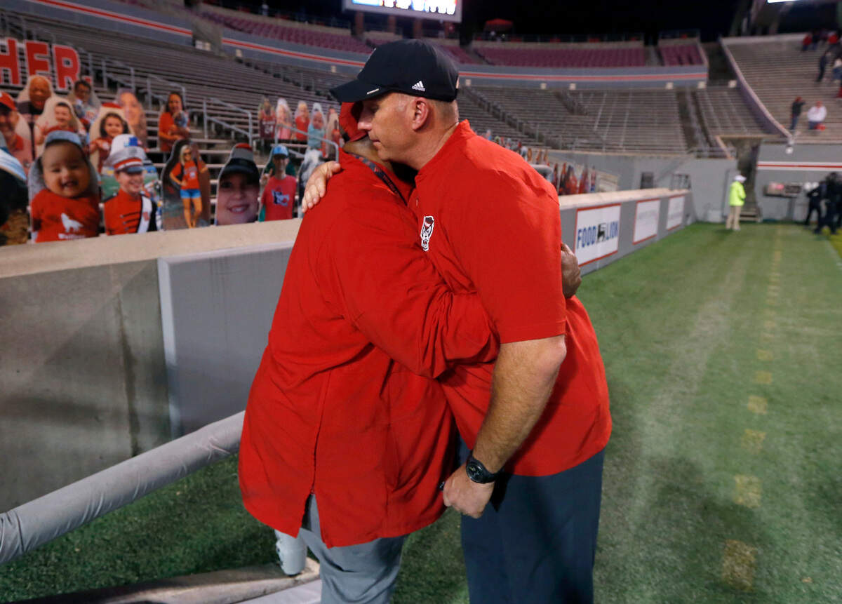 N.C. State head coach Dave Doeren hugs special assistant to the head coach Ruffin McNeill after N.C. State’s 31-20 victory over Duke at Carter-Finley Stadium in Raleigh, N.C., Saturday, Oct. 17, 2020.