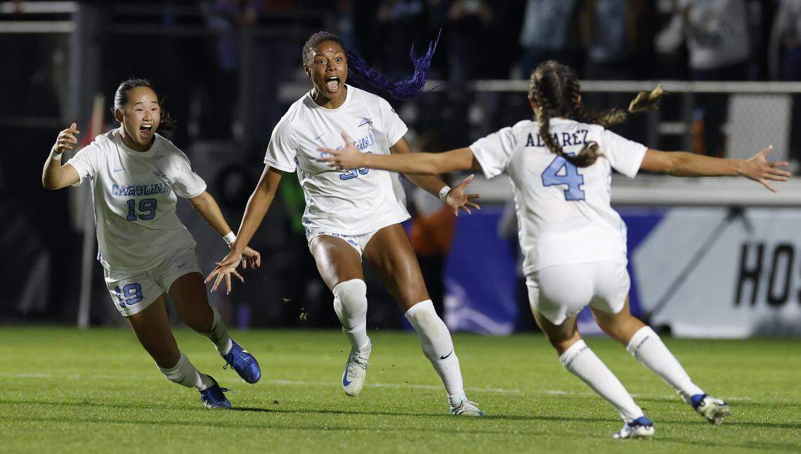 North Carolina's Olivia Thomas (33) celebrates scoring in the second half of UNC’s 1-0 victory over Wake Forest in the finals of the 2024 Women’s College Cup at WakeMed Soccer Park in Cary, N.C., Monday, Dec. 9, 2024. With her are North Carolina's Aria Nagai (19) and Aven Alvarez (4)