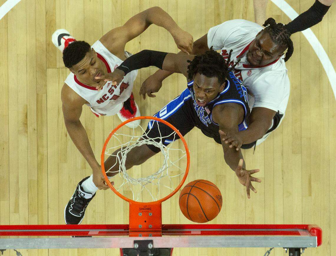 Duke’s Mark Mitchell lays in a shot over N.C. State’s Casey Morsell and DJ Burns Jr. during the second half of the Blue Devils’ 79-64 win on Monday, March 4, 2024, at PNC Arena in Raleigh, N.C.
