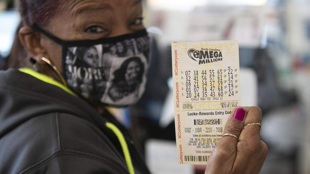 Beverly Burk of Raleigh plays the Mega Millions lottery at Eagles Express convenience store on Thursday, January 21, 2021 in Knightdale, NC. The jackpot is $970 million and growing with the next drawing on Friday, January 22, 2021.