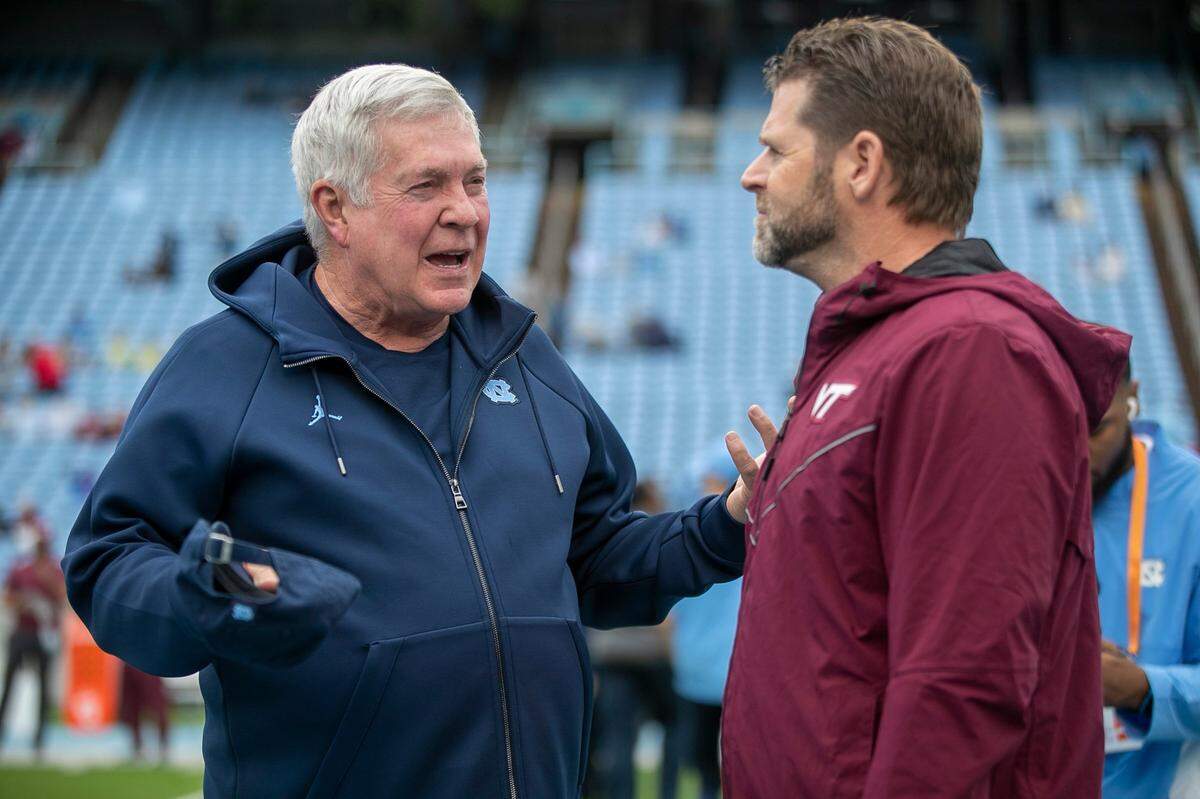 North Carolina coach Mack Brown talks with Virginia Tech head coach Brent Pry prior to their game on Saturday, October 1, 2022 at Kenan Stadium in Chapel Hill, N.C.