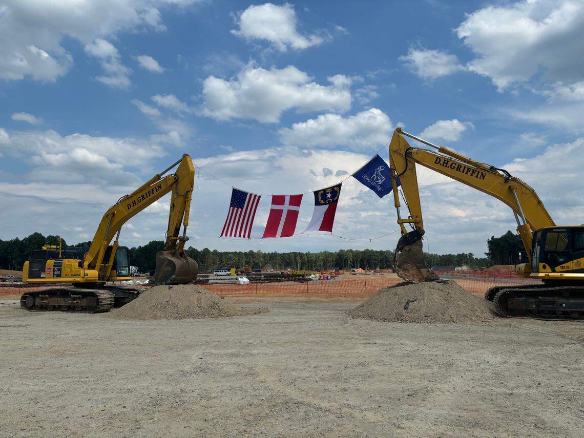Excavators at the future Novo Nordisk expansion site in Clayton, NC hoist up U.S., Denmark, and North Carolina flags on June 24, 2024.