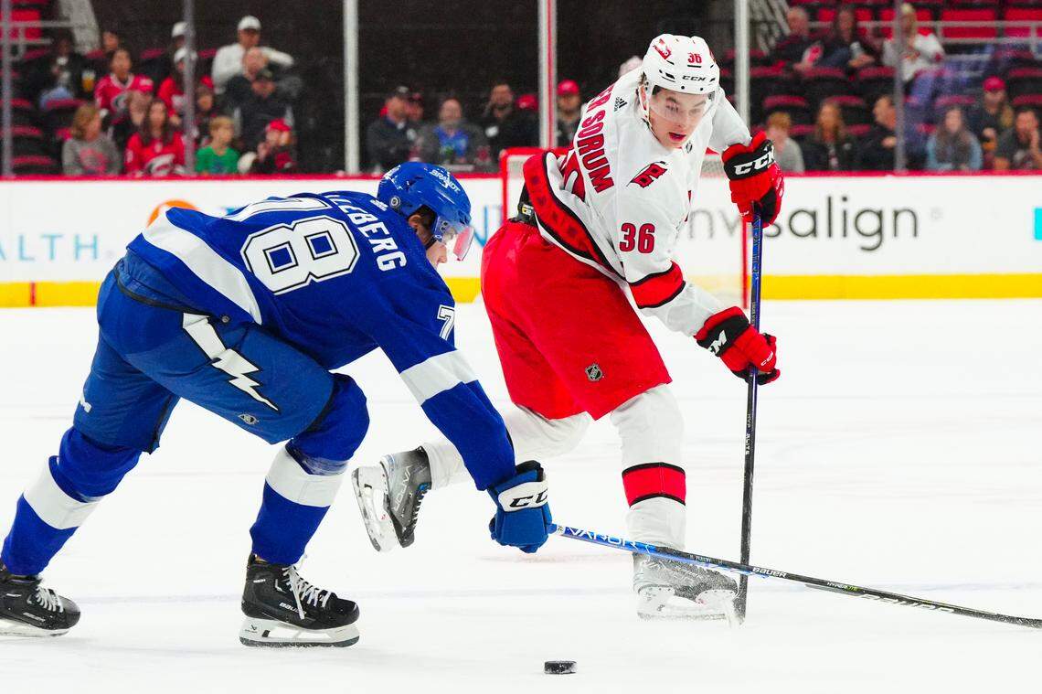 Sep 26, 2023; Raleigh, North Carolina, USA; Carolina Hurricanes right wing Felix Unger Sorum (36) makes a pass against Tampa Bay Lightning Emil Lilleberg (78) during the first period at PNC Arena. Mandatory Credit: James Guillory-USA TODAY Sports
