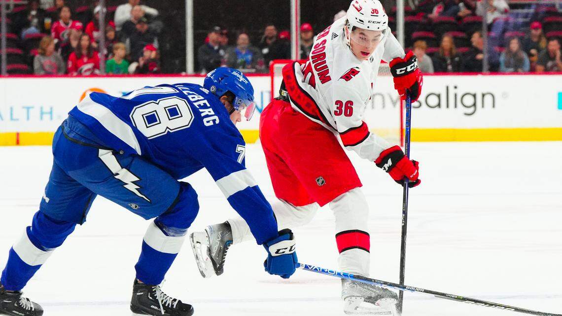 Sep 26, 2023; Raleigh, North Carolina, USA; Carolina Hurricanes right wing Felix Unger Sorum (36) makes a pass against Tampa Bay Lightning Emil Lilleberg (78) during the first period at PNC Arena. Mandatory Credit: James Guillory-USA TODAY Sports