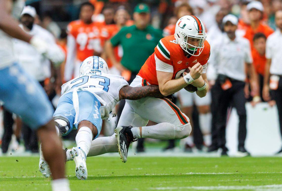 North Carolina Tar Heels linebacker Power Echols (23) tackles Miami Hurricanes quarterback Tyler Van Dyke (9) during the second quarter of an ACC conference football game at Hard Rock Stadium on Saturday, October 8, 2022 in Miami Gardens, Florida..
