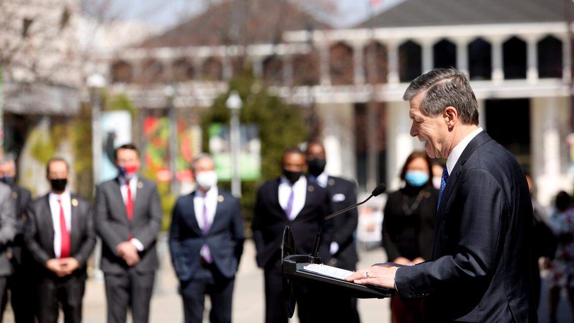North Carolina Democratic Gov. Roy Cooper, right, and lawmakers gathered March 10, 2021, for a joint press conference about a schools reopening deal. The same day, a bill was filed in the House to curb the governor’s powers during a state of emergency.