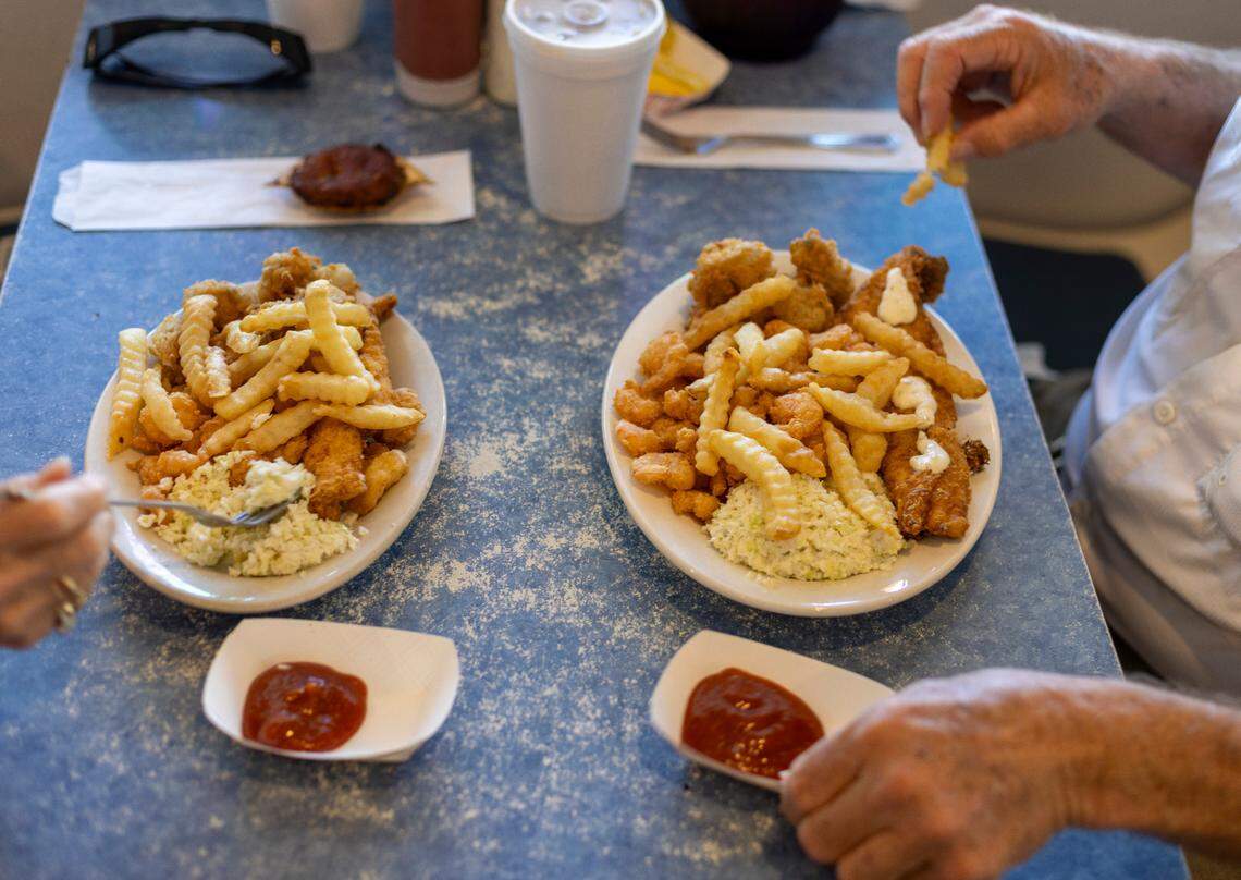 David and Kelly Harrison of Blacksburg, Va. dine on their seafood platters during lunch at the Calabash Seafood Hut on Saturday, June 29, 2024 in Calabash, N.C. They dine at the Calabash Seafood Hut everyday they are on vacation, usually arriving by 10:30 a.m. to be the first inside.