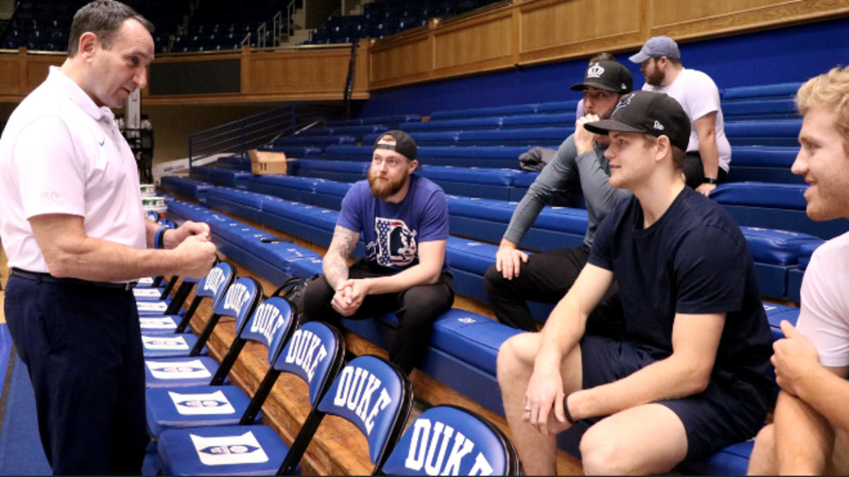 Duke basketball coach Mike Krzyzewski speaks with Carolina Hurricanes players, from left, Scott Darling, Clark Bishop, Warren Foegele and Dougie Hamilton after a practice at Cameron Indoor Stadium on Oct. 19, 2018.
