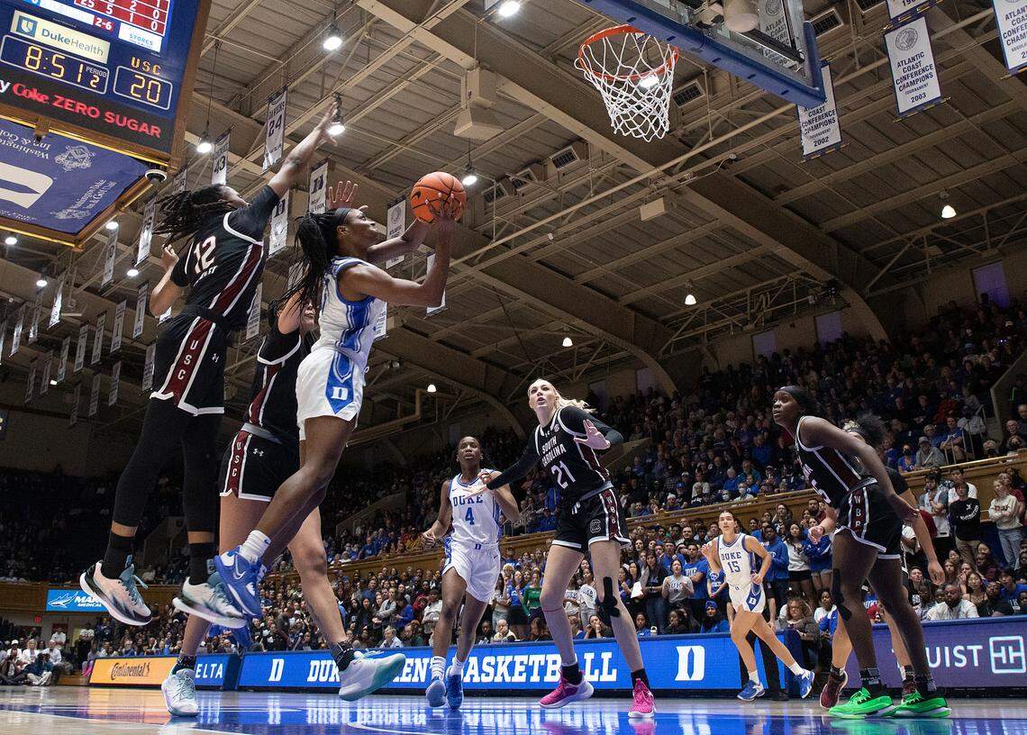 Duke’s Oluchi Okananwa drives to the basket past South Carolina’s MiLaysia Fulwiley and Kamilla Cardoso during the first half of the Blue Devils’ 77-61 loss on Sunday, Dec. 3, 2023, at Cameron Indoor Stadium in Durham, N.C.