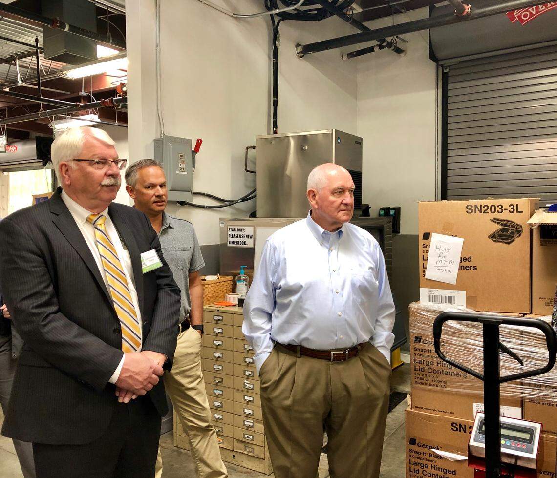 U.S. Agriculture Secretary Sonny Perdue, right, tours the Inter-Faith Food Shuttle in Raleigh on Tuesday, June 4. He was joined by N.C. Agriculture Commissioner Steve Troxler, left, and N.C. Lieutenant Governor Dan Forest, middle.