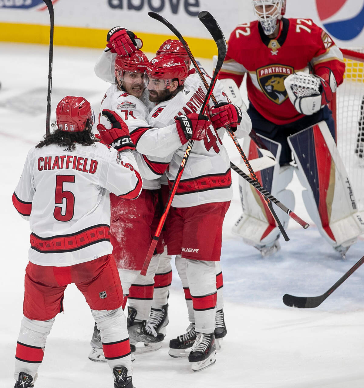The Carolina Hurricanes Jesper Fast (71) celebrates with Paul Stastny (26), Jalen Chatfield (5) and Jordan Martinook (48) after scoring in the third period to tie the Florida Panthers 3-3 during game 4 of the Eastern Conference Finals on Wednesday, May 24, 2023 at FLA Live Arena in Sunrise, Fla.