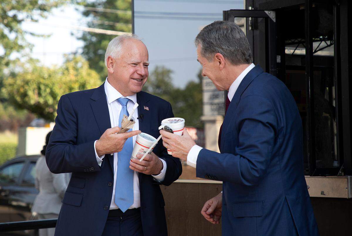 Democratic Vice Presidential nominee and Minnesota Gov. Tim Walz orders a Cook Out milkshake with Gov. Roy Cooper during a visit to Raleigh, N.C. on Thursday, Aug. 29, 2024.