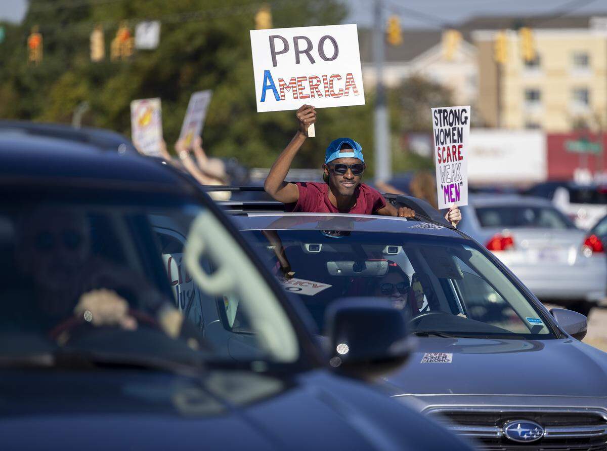 Demonstrators in cars cruise along Capital Blvd. interacting with those lining the road during the ‘No Kings’ protest on Saturday, October 18, 2025 in Raleigh, N.C