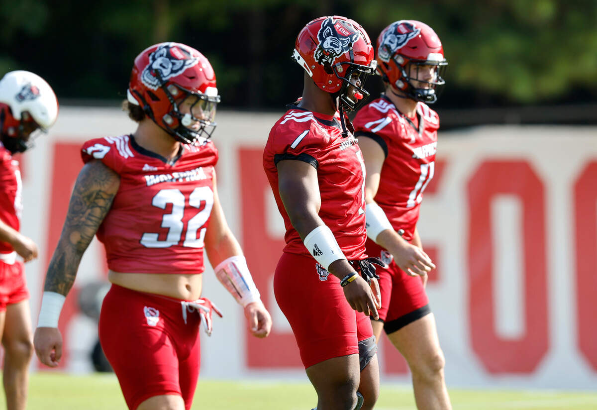 From left N.C. State linebackers Drake Thomas (32), Isaiah Moore (1) and Payton Wilson (11) line up for a drill during the Wolfpack’s first practice of fall camp in Raleigh, N.C., Wednesday, August 3, 2022.