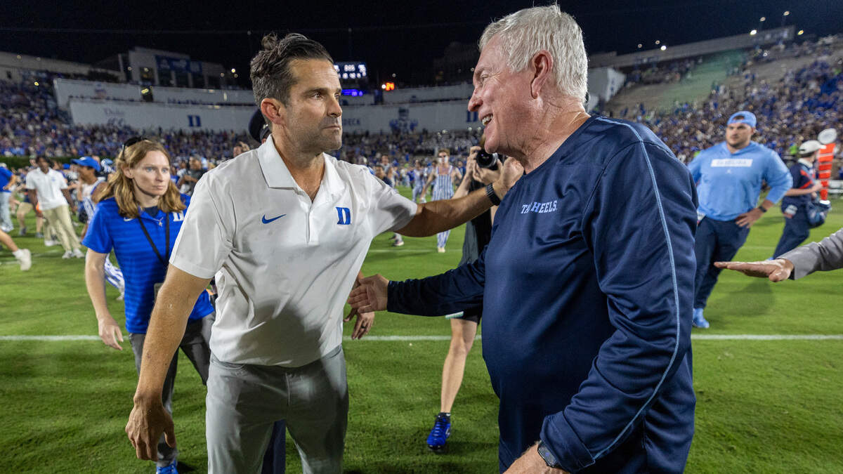 North Carolina coach Mack Brown congratulates Duke coach Manny Diaz following the Blue Devils’ victory on Saturday, September 28, 2024 at Wallace Wade Stadium in Durham, N.C. Duke scored 21 unanswered points to defeat North Carolina 21-20.