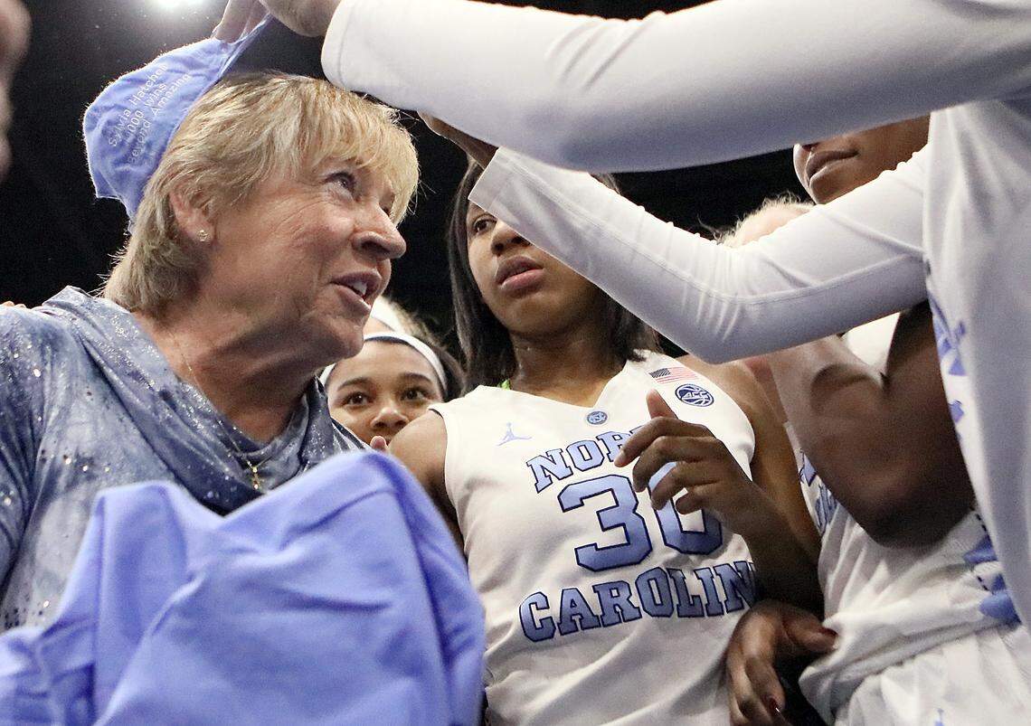Celebrating with her team, the University of North Carolina’s Sylvia Hatchell gets her 1,000 career win in the game over Grambling State University on Dec. 19, 2017. N