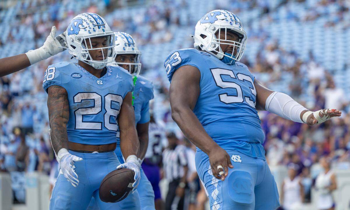 North Carolina offensive lineman Willie Lampkin (53) celebrates with Omarion Hampton (28) after Hampton scored on a 2-yard run in the fourth quarter against James Madison on Saturday, September 21, 2024 at Kenan Stadium in Chapel Hill, N.C.