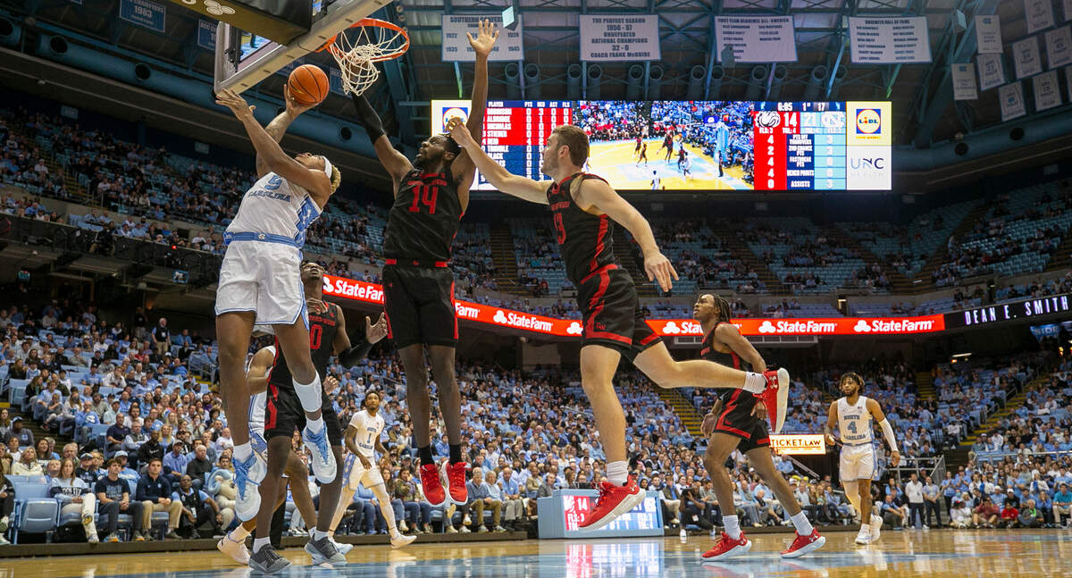 North Carolina’s Armando Bacot (5) muscles his way to the basket against Gardner-Webb’s Kareem Reid (14) during the first half on Tuesday, November 15, 2022 at the Smith Center in Chapel Hill, N.C.