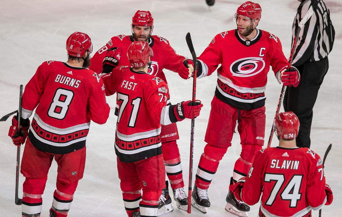 The Carolina Hurricanes Jesper Fast (71) is surrounded by teammates after scoring on an open net in the third period to secure a 5-1 victory over the New Jersey Devils in Game 1 of their second round Stanley Cup playoff series on Wednesday, May 3, 2023 at PNC Arena in Raleigh, N.C.