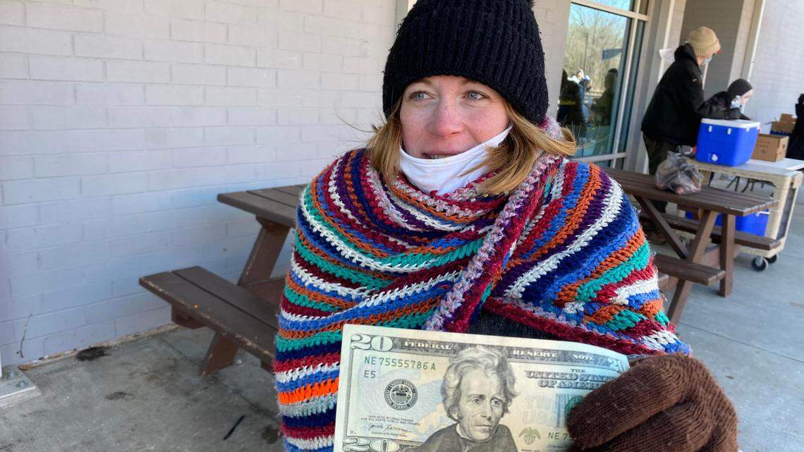 Tiffany Edwurds, 40, has been homeless in Raleigh since May of 2020. She is one of several dozen people who received $20 in cash from the Rev. Phil Brickle Saturday.