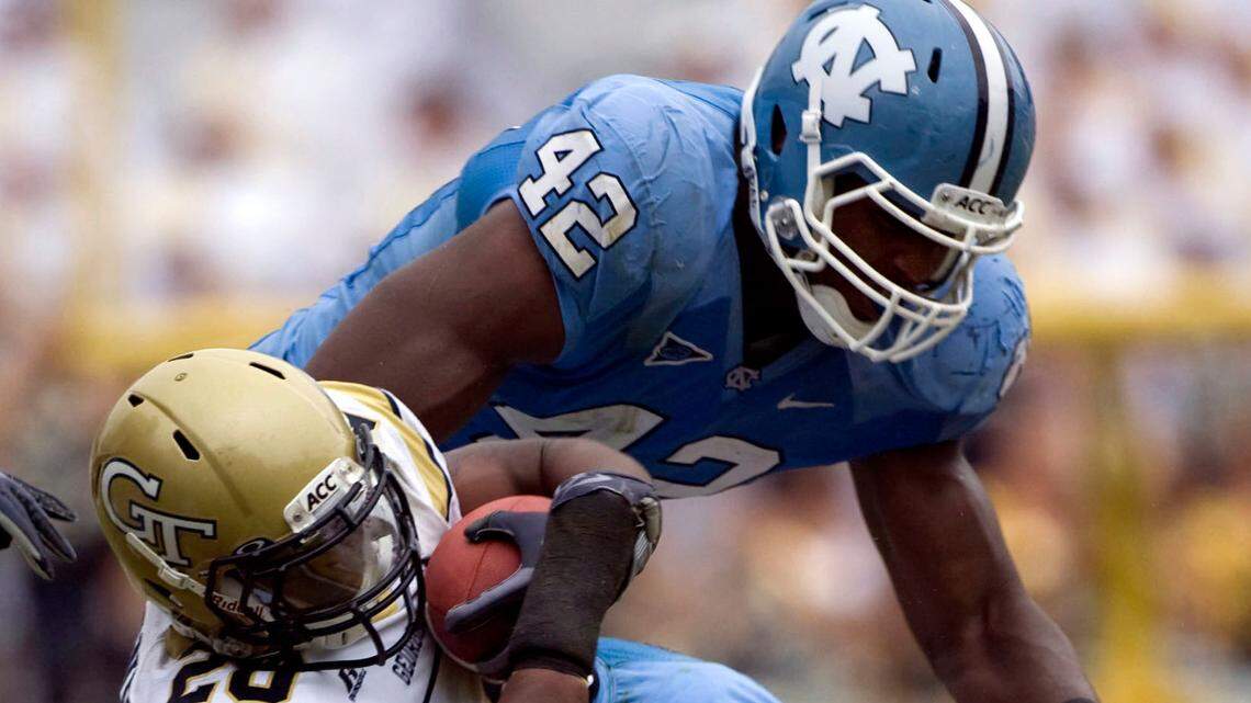 Georgia Tech’s Roddy Jones (20) is stopped after a two yard gain by UNC’s Kendric Burney (16) and Robert Quinn (42) in the fourth quarter on Saturday September 26, 2009 . ROBERT WILLETT -robert.willett@newsobserver.com