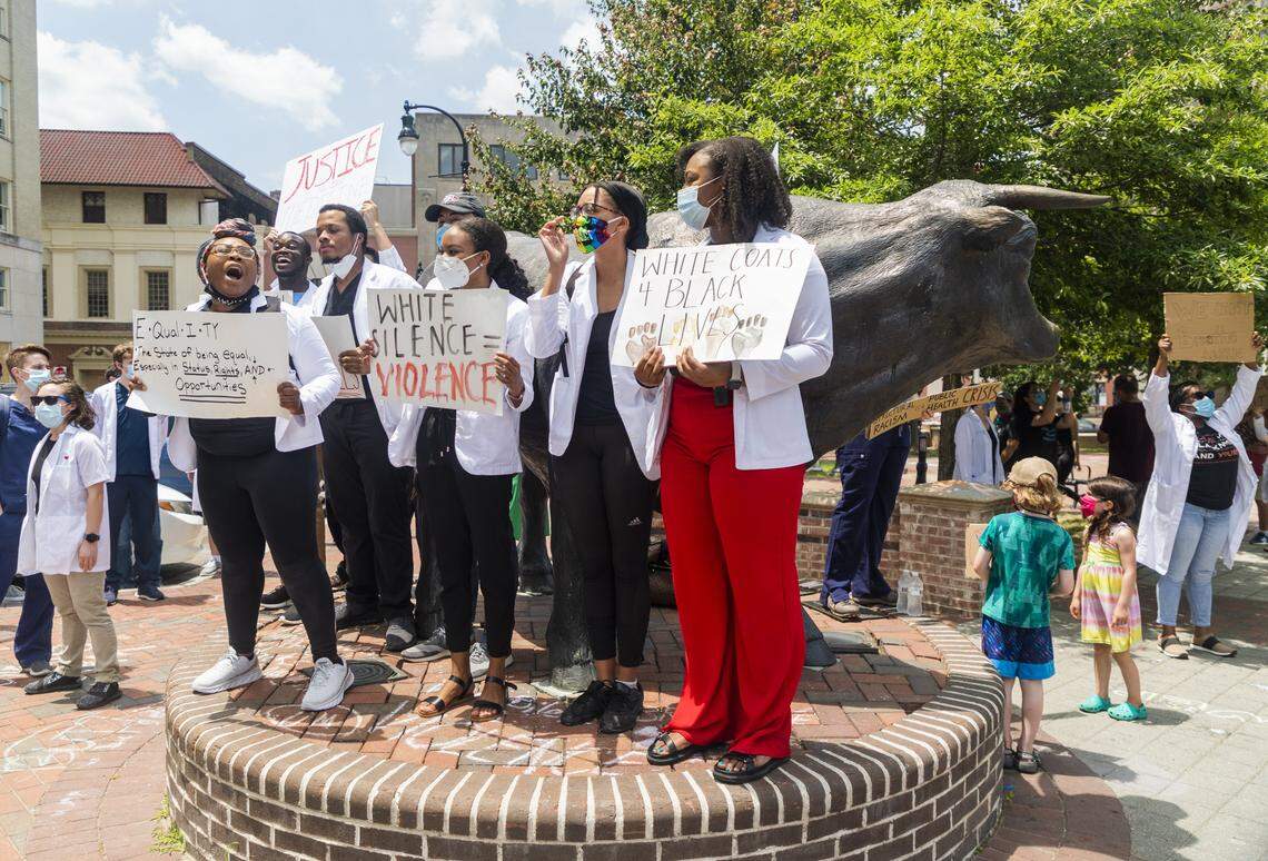 Organizers of the Triangle Health Care Workers for Black Lives march, that brought hundreds of healthcare workers together to protest in the wake of the death of George Floyd, lead the crowd in chants at CCB Plaza, on Saturday, Jun. 6, 2020, in Durham, N.C.