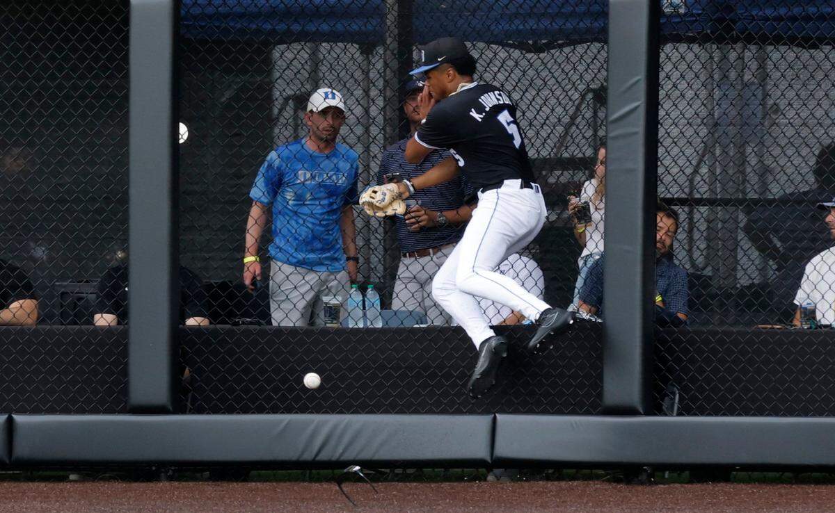 Duke’s Kyle Johnson (5) crashes into the wall as he chases a fly ball during Duke’s game against Murray State in the third game of the Durham Super Regional at Jack Coombs Field in Durham, N.C., Monday, June 9, 2025.