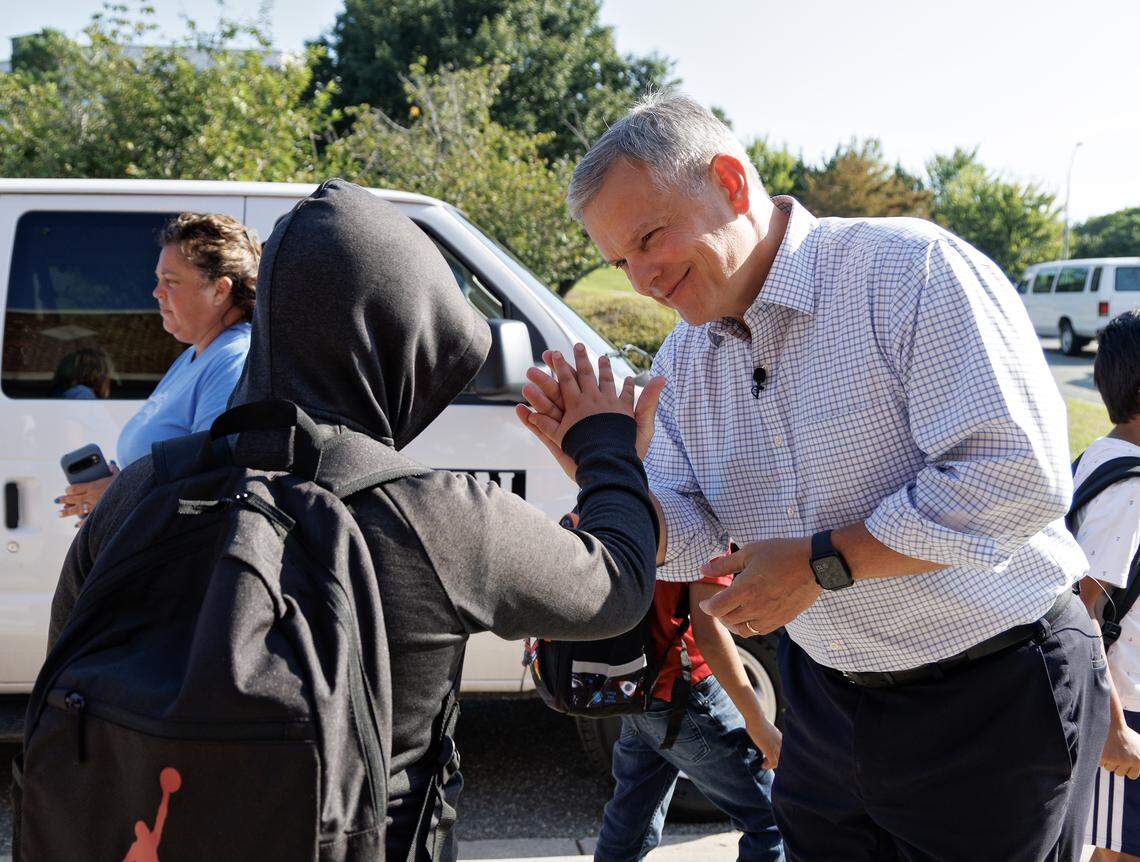 Gov. Josh Stein greets a student on the first day of school at Washington Elementary School on Monday, Aug. 25, 2025, in Raleigh, N.C.