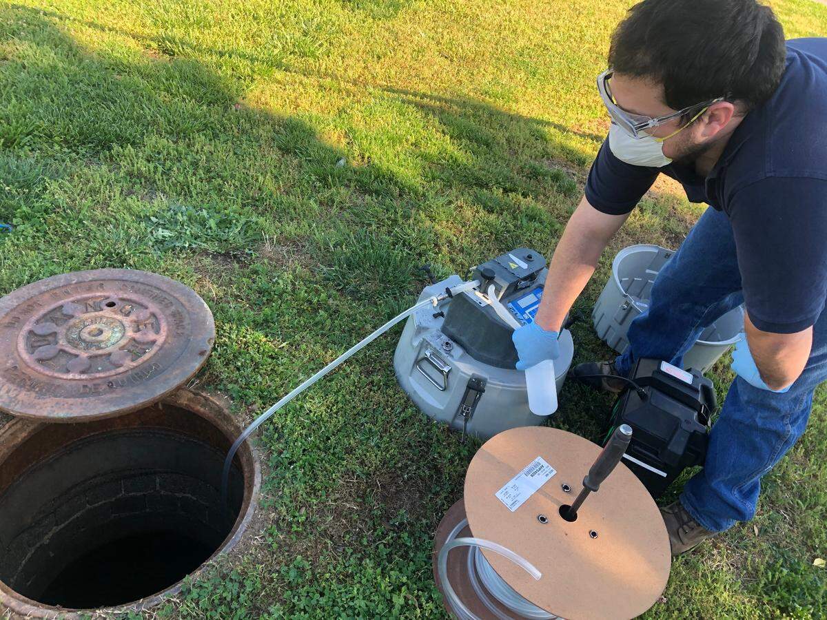 Kevin Heavner, a pretreatment specialist at the Neuse River Resources Reclamation Facility, collects a wastewater sample.