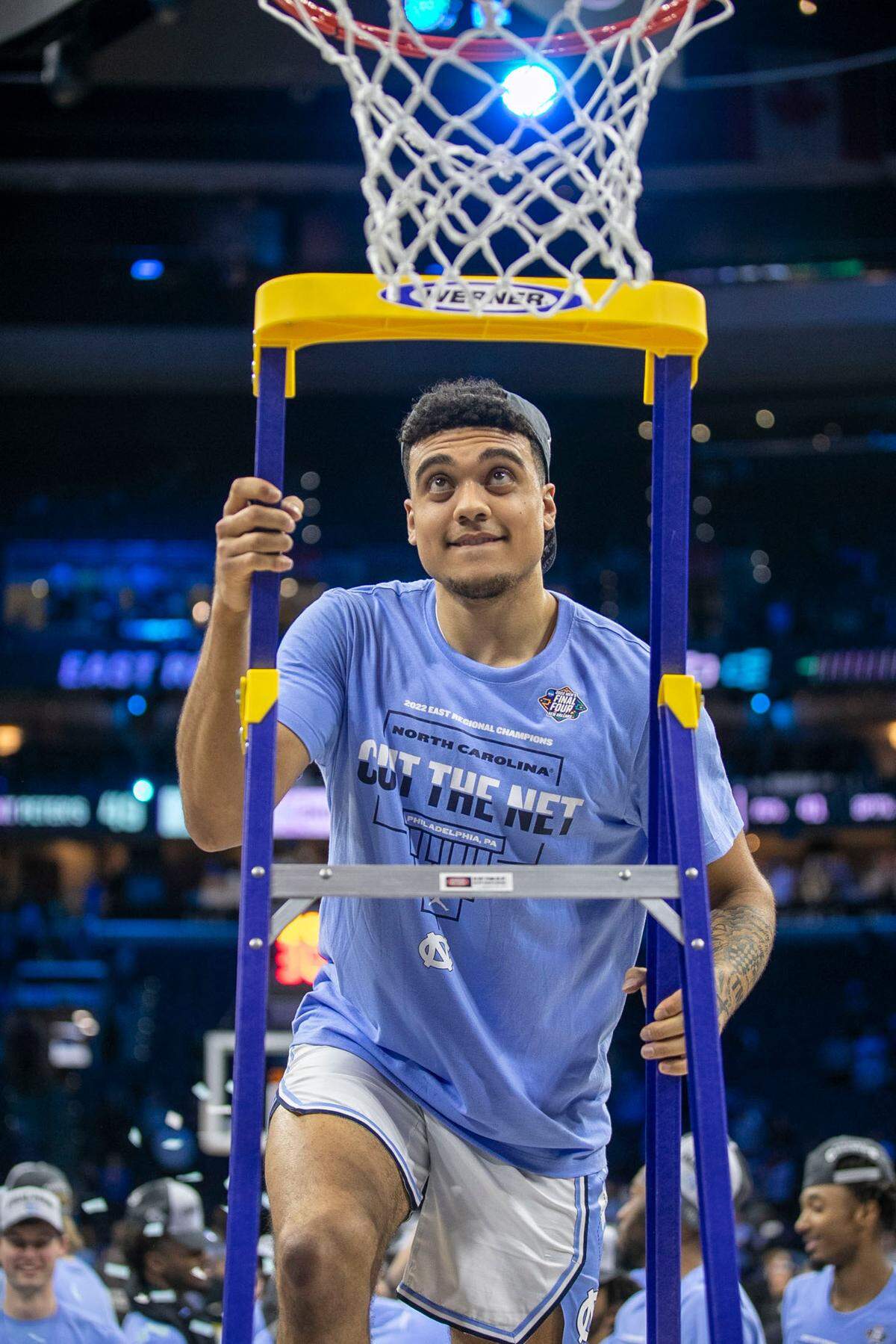 North Carolina’s Justin McKoy (22) climbs the ladder to cut down the net following the Tar Heels’ 69-49 victory over Saint Peter’s in the NCAA East Regional Championship game on Sunday, March 27, 2022 at Wells Fargo Center in Philadelphia, Pa.