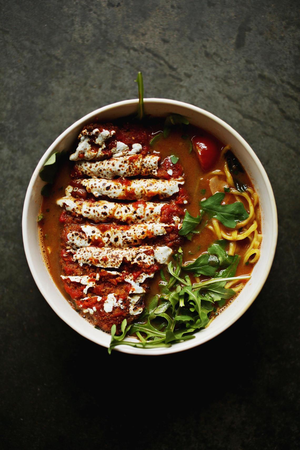 The chicken parm ramen is made up of tomato tori paitan, arugula and chicken katsu at Italian-Japanese fusion restaurant Papa Shogun in Raleigh.