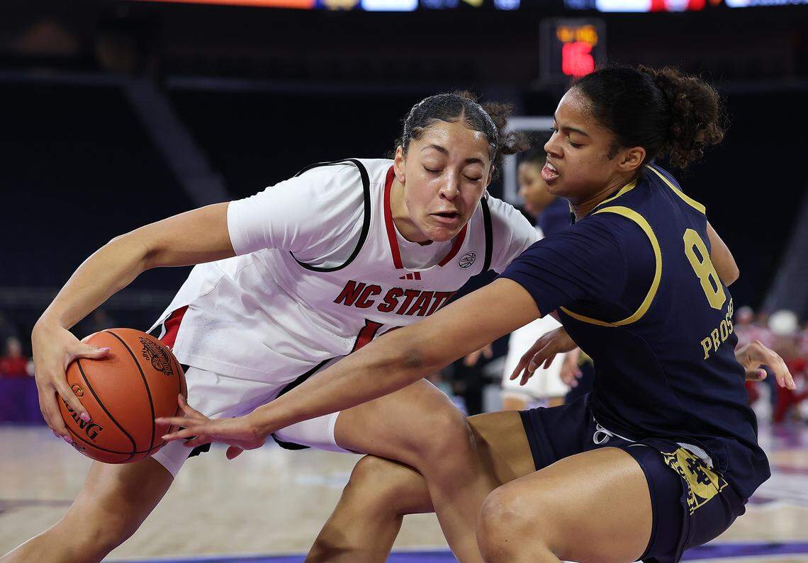 Khamil Pierre (12) of the N.C. State Wolfpack drives against Cassandre Prosper of the Notre Dame Fighting Irish during the first quarter of the teams’ ACC Women’s Tournament quarterfinal at Gas South Arena on March 6, 2026 in Duluth, Georgia.