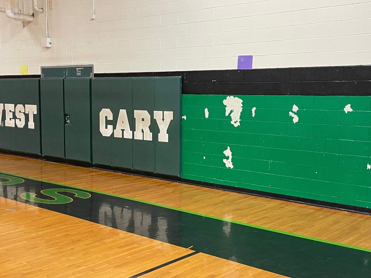 Tape holds up the school sign along the back wall of the gym at West Cary Middle School. Parents and teachers are lobbying for major renovations to the Cary school.