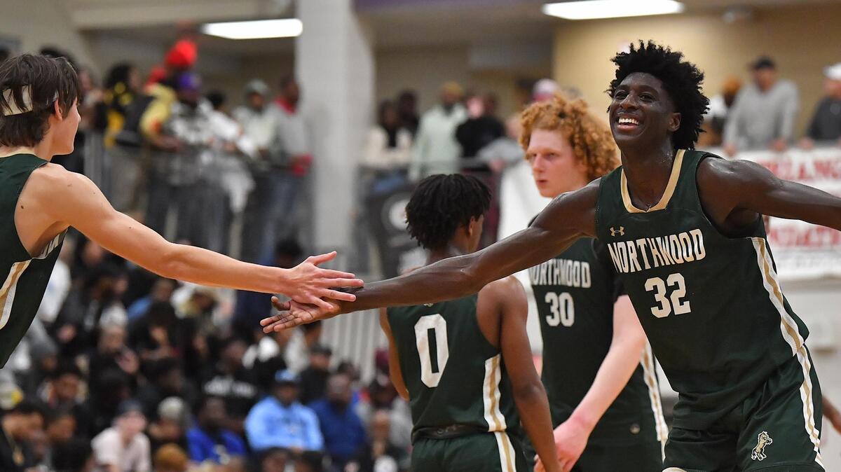 Northwood’s Drake Powell (32) celebrates with Jake Leighton (33) after a play against Camden. The Camden (NJ) Panthers and the Northwood Chargers met in the John Wall Holiday Invitational in Raleigh, N.C. on December 28,2022 .
