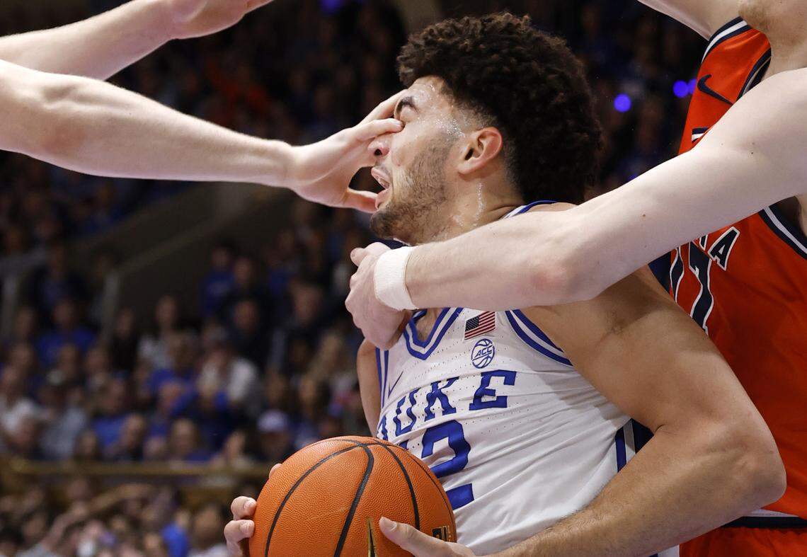 Duke’s Cameron Boozer (12) is hit in the eye as he moves towards the basket during the first half of Duke’s game against Virginia at Cameron Indoor Stadium in Durham, N.C., Saturday, Feb. 28, 2026. Boozer would leave the floor but returned a little bit later.
