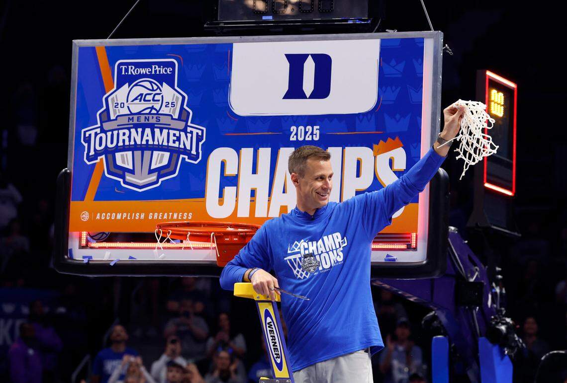 Duke head coach Jon Scheyer holds the net after cutting it down after Duke’s 73-62 victory over Louisville in the finals of the 2025 ACC Men’s Basketball Tournament at the Spectrum Center in Charlotte, N.C., Saturday, March 15, 2025.