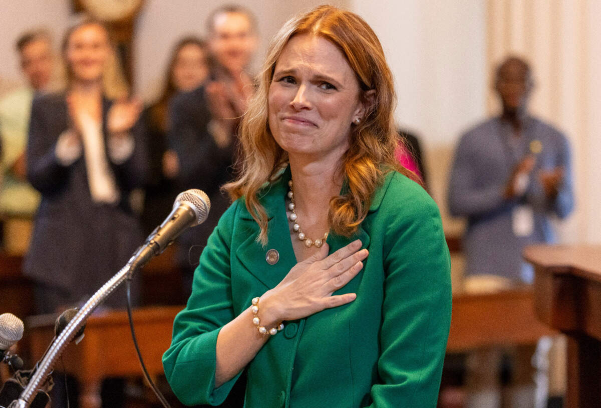 Supreme Court Justice Allison Riggs touches her heart as she acknowledges her parents before making remarks following her swearing-in at the House Chamber of the State Capitol on Tuesday, May 13, 2025 in Raleigh, N.C.